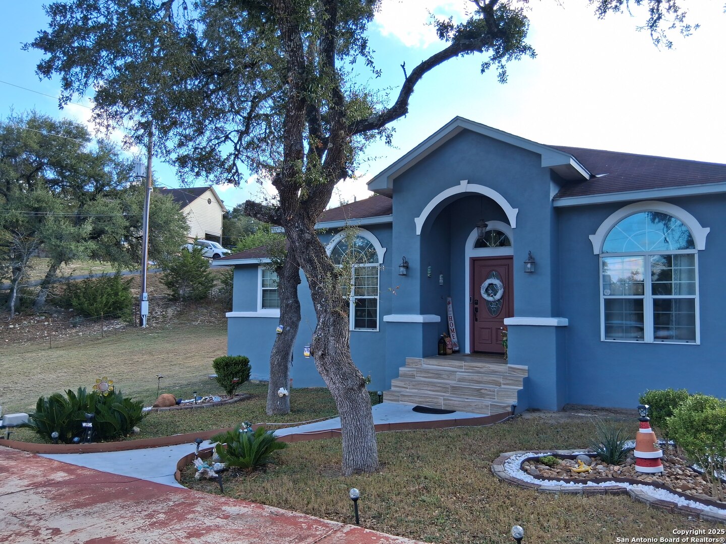 7061 Devonshire Drive Spring Branch, TX 78070 - Photo 2 of 52 a front view of a house with garden
