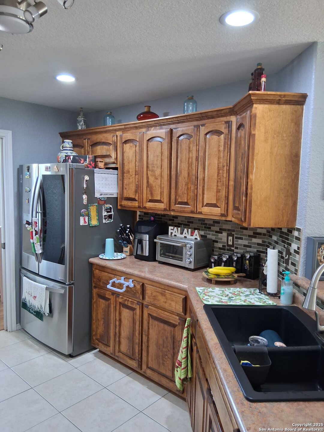 7061 Devonshire Drive Spring Branch, TX 78070 - Photo 22 of 52 a kitchen with stainless steel appliances granite countertop a refrigerator and a sink