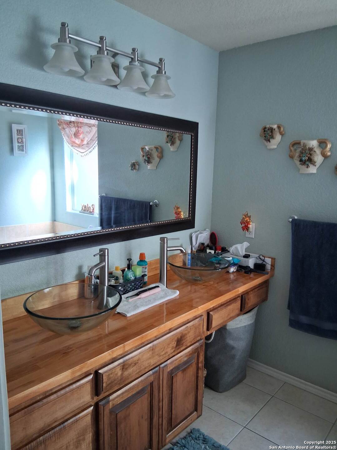 7061 Devonshire Drive Spring Branch, TX 78070 - Photo 25 of 52 a room with stainless steel appliances a sink and a dresser with wooden floor