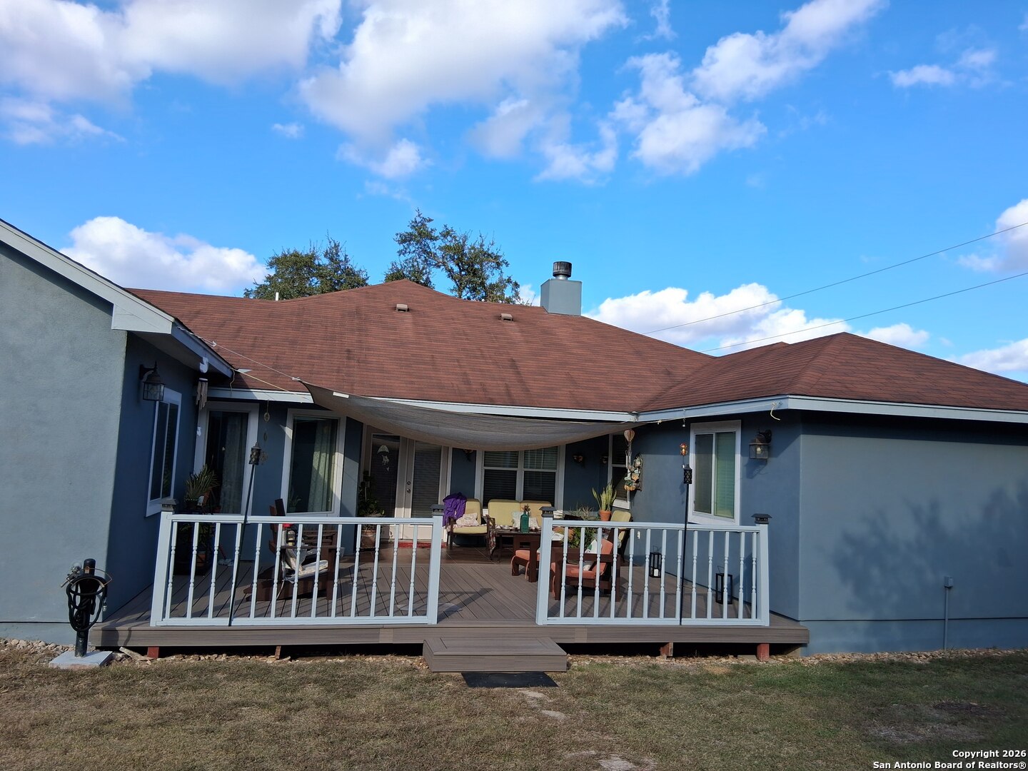 7061 Devonshire Drive Spring Branch, TX 78070 - Photo 34 of 52 a view of a house with wooden deck and a yard
