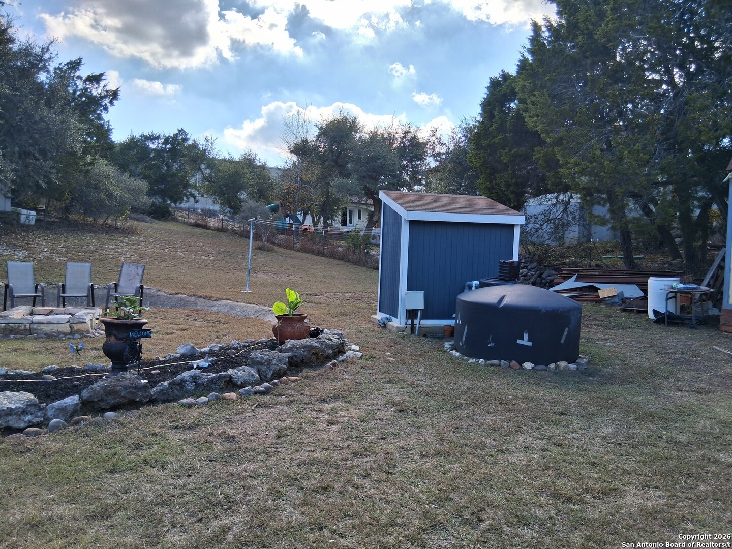 7061 Devonshire Drive Spring Branch, TX 78070 - Photo 36 of 52 a wooden bench sitting in the middle of a lake