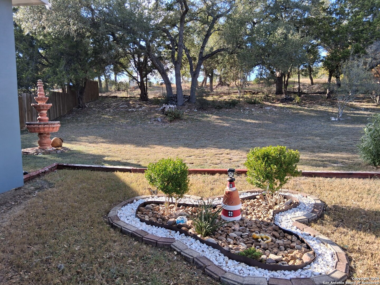 7061 Devonshire Drive Spring Branch, TX 78070 - Photo 37 of 52 a view of a backyard with plants and trees