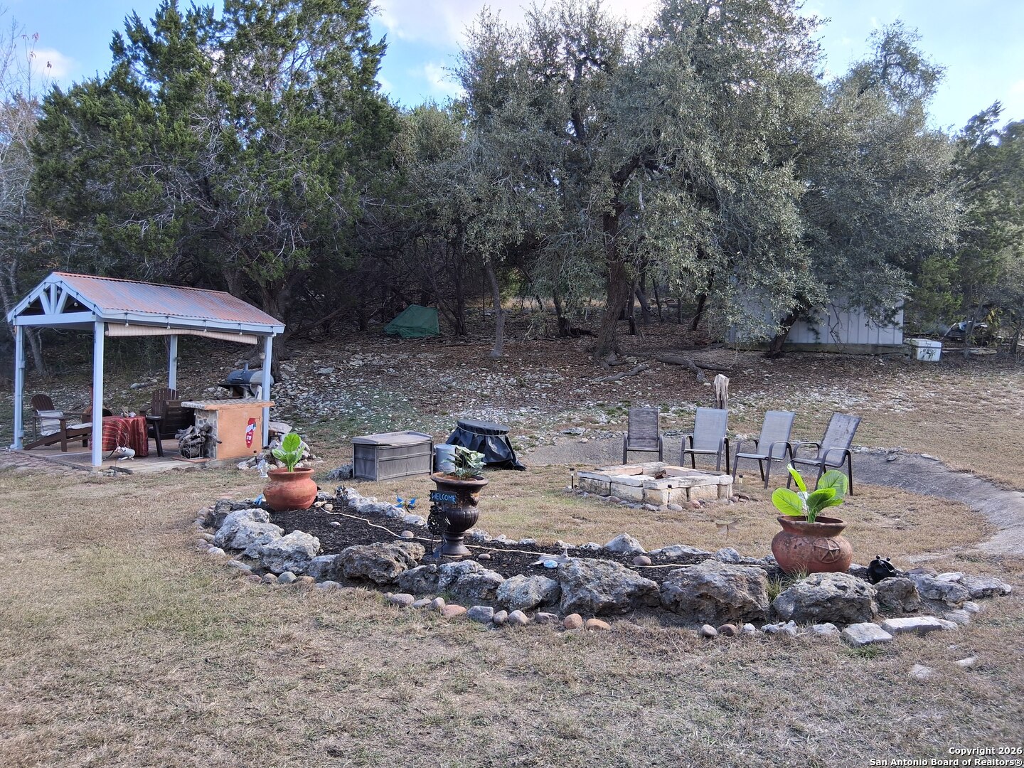 7061 Devonshire Drive Spring Branch, TX 78070 - Photo 38 of 52 a view of a chairs and tables in the back yard