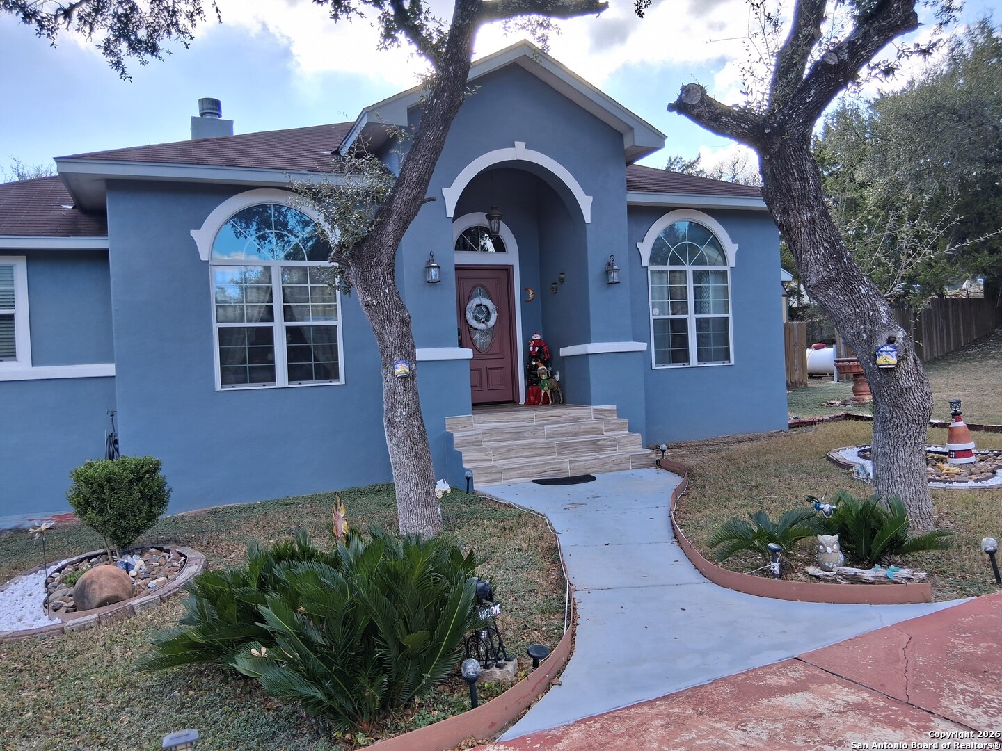 7061 Devonshire Drive Spring Branch, TX 78070 - Photo 4 of 52 a front view of a house with garden
