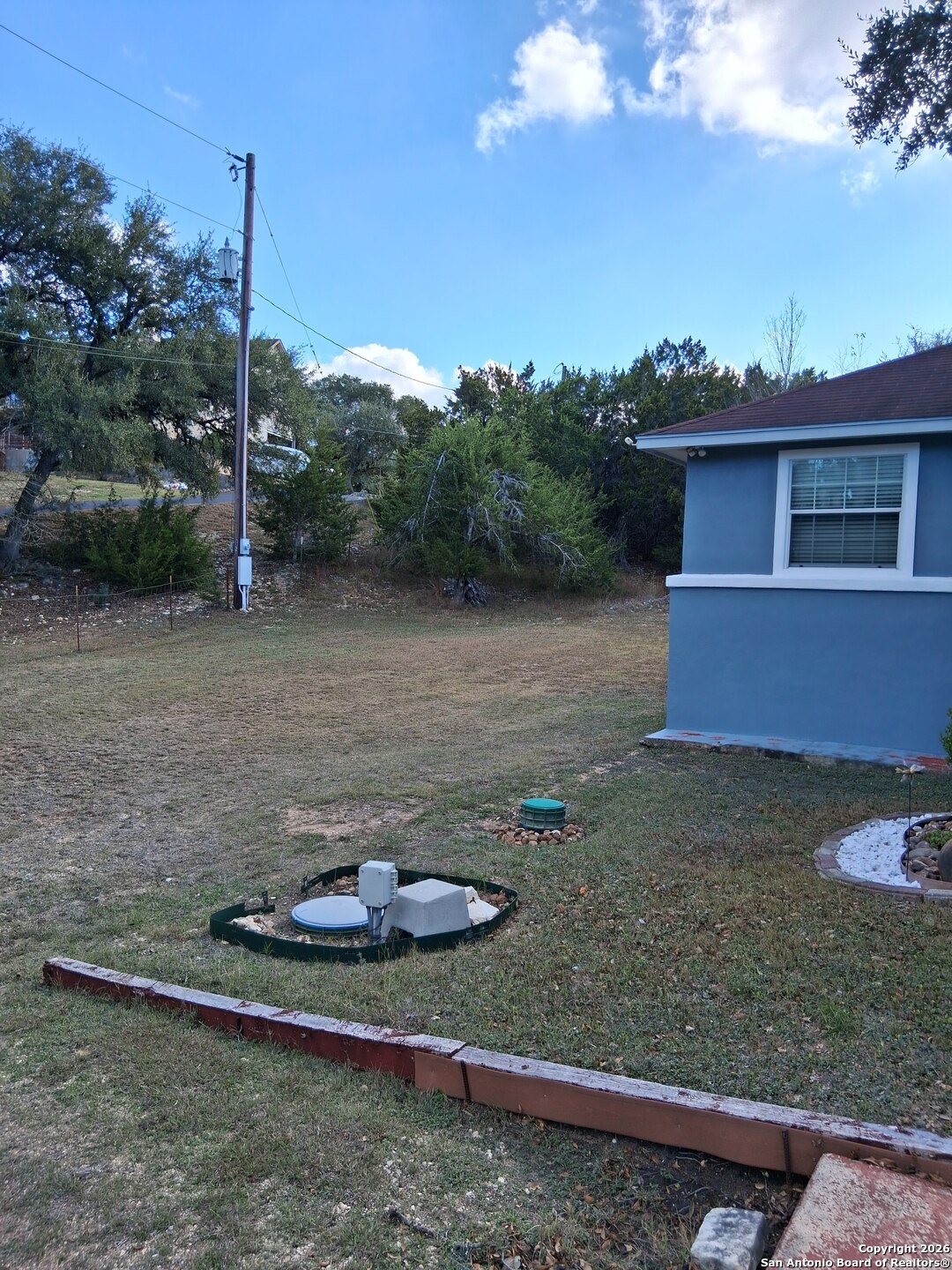 7061 Devonshire Drive Spring Branch, TX 78070 - Photo 41 of 52 a backyard of a house with lots of green space