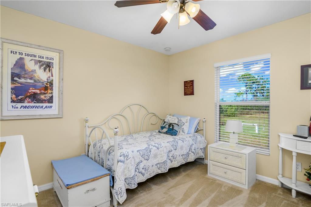 113 Northeast 29th Street Cape Coral, FL 33909 - Photo 13 of 19 a bedroom with a bed and a chandelier