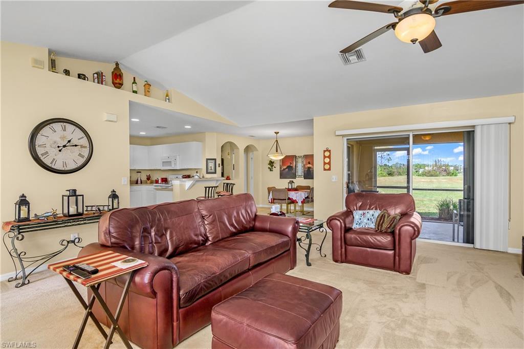 113 Northeast 29th Street Cape Coral, FL 33909 - Photo 4 of 19 a living room with furniture a clock tv and a window