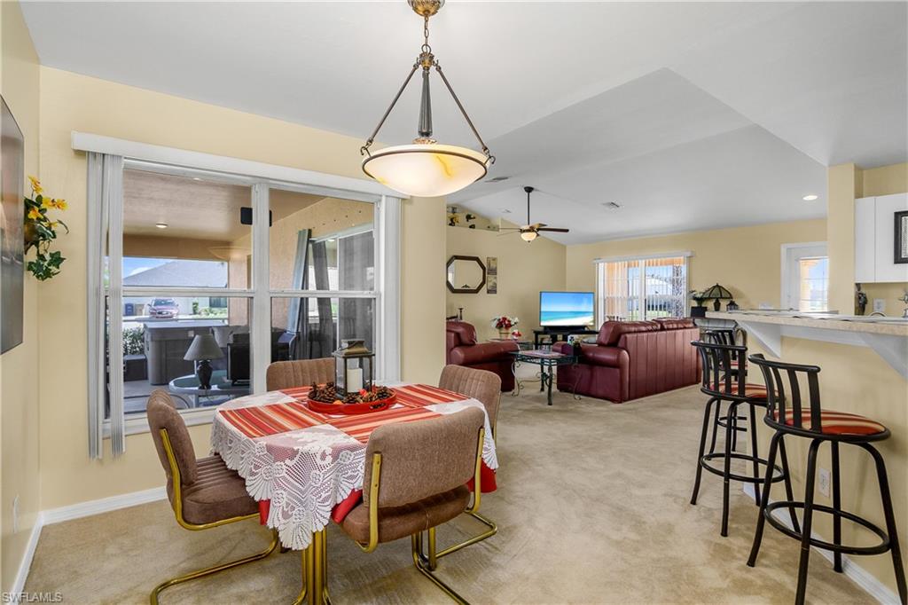 113 Northeast 29th Street Cape Coral, FL 33909 - Photo 5 of 19 a living room with furniture a chandelier and a table