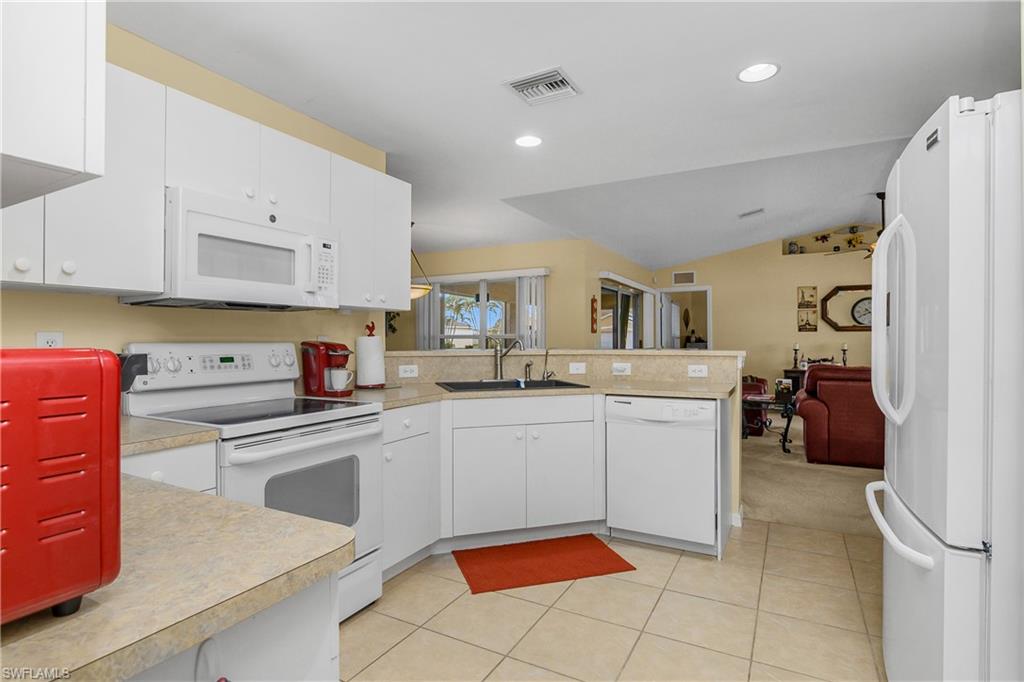 113 Northeast 29th Street Cape Coral, FL 33909 - Photo 6 of 19 a kitchen with cabinets and chairs