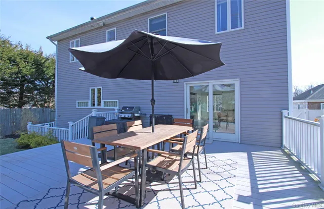 a patio with a table and chairs under an umbrella