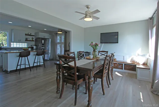 a view of a dining room with furniture window and wooden floor