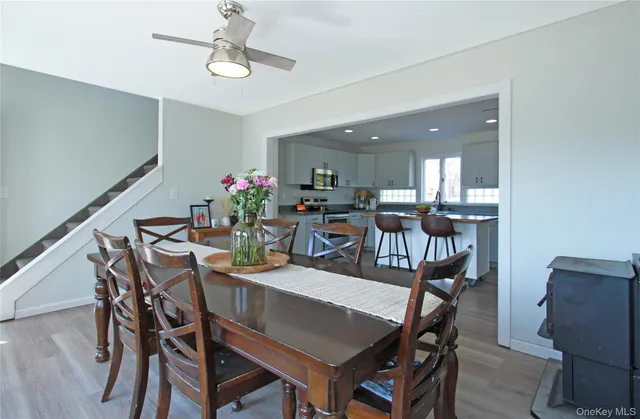 a view of a dining room with furniture and wooden floor