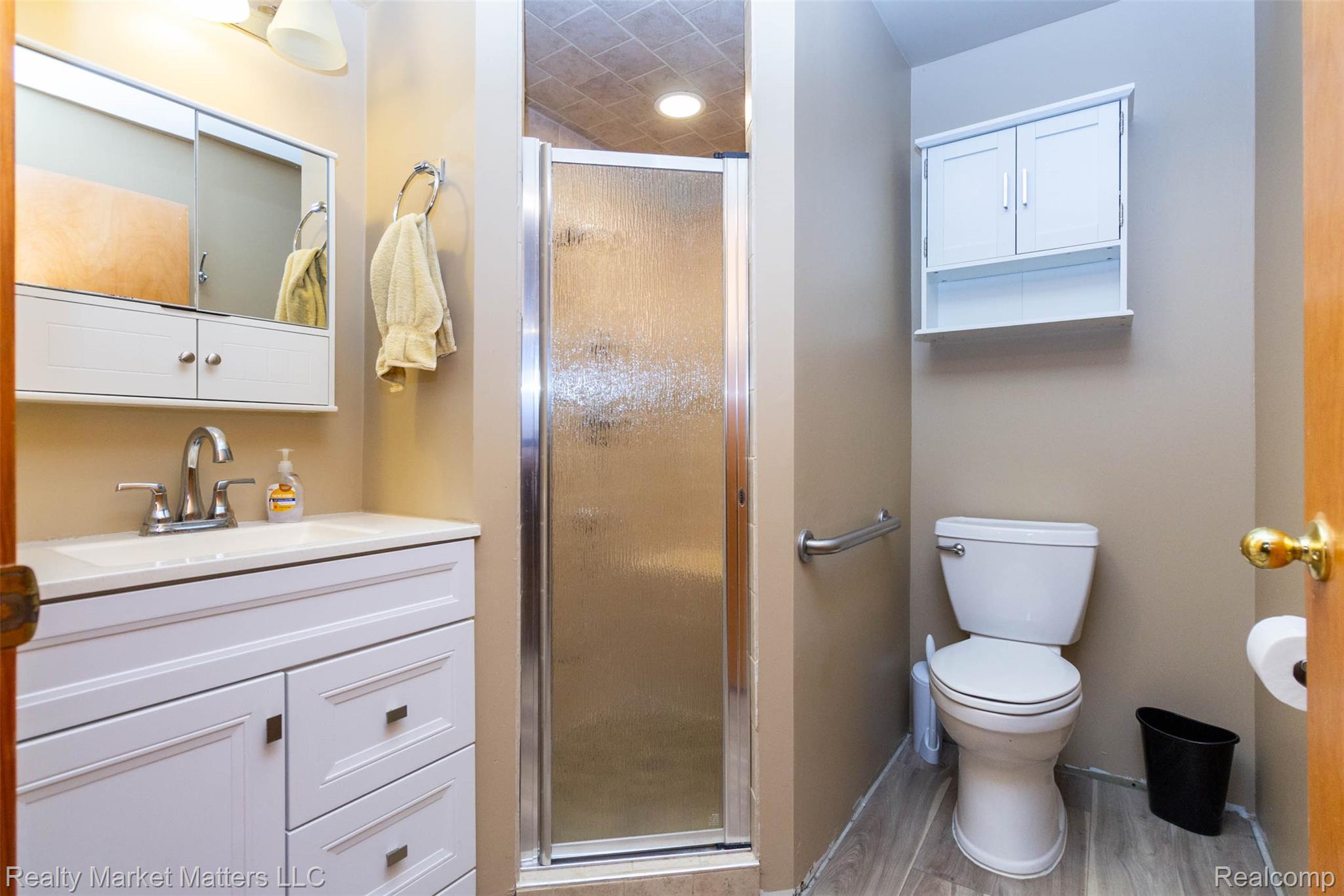 4951 Laur Road North Branch, MI 48461 - Photo 18 of 34 Bathroom featuring a white vanity with integrated sink, chrome faucet, and mirrored medicine cabinet