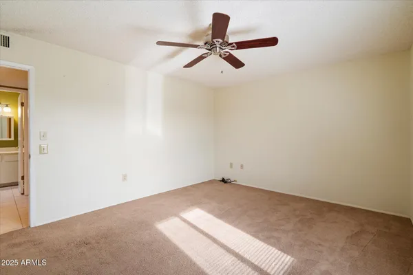 a view of a room with a ceiling fan