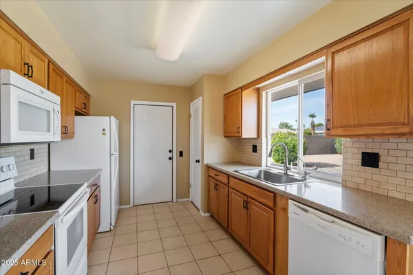 a kitchen with stainless steel appliances a sink stove and cabinets