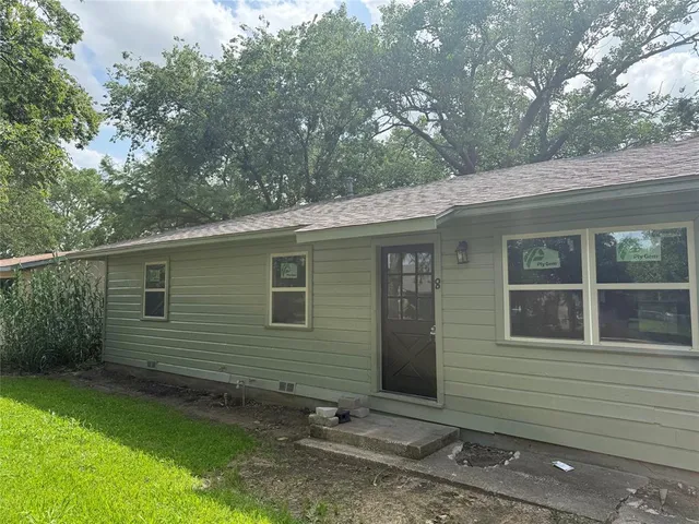 a view of a backyard with a large tree