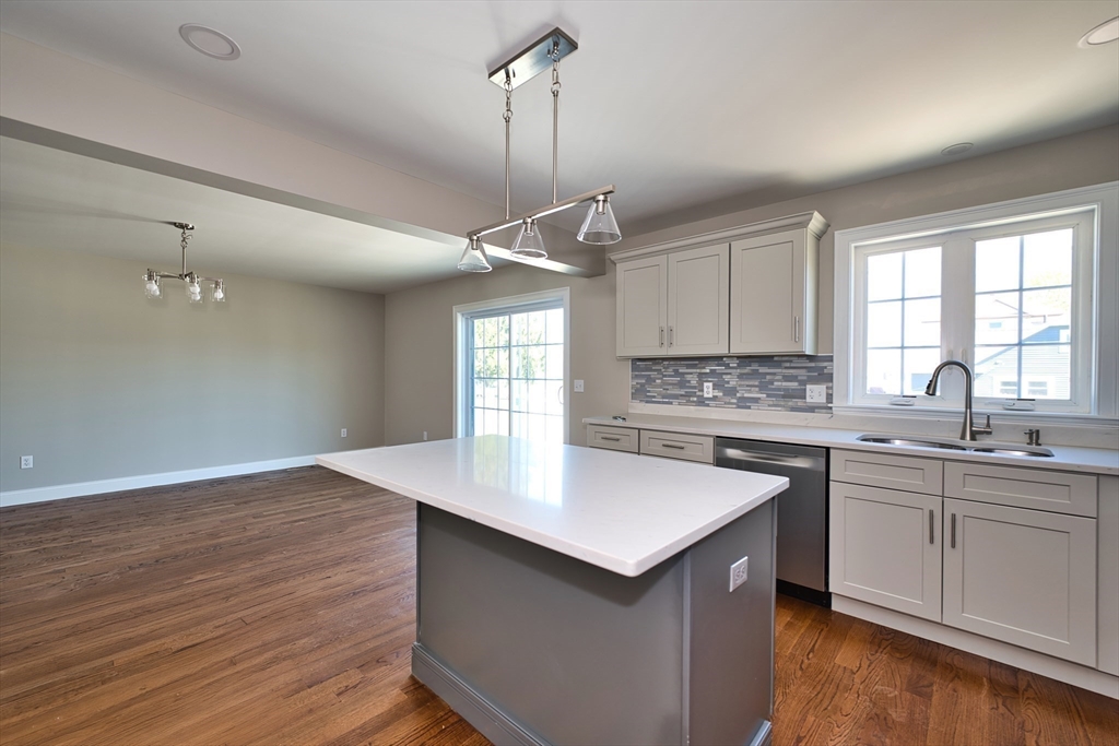 124 Downing Street Fall River, MA 02723 - Photo 15 of 33 a kitchen with a sink cabinets and window