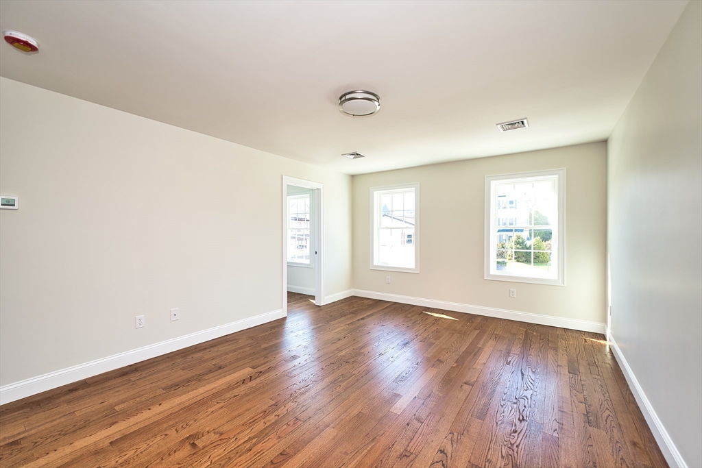 124 Downing Street Fall River, MA 02723 - Photo 18 of 33 an empty room with wooden floor and windows