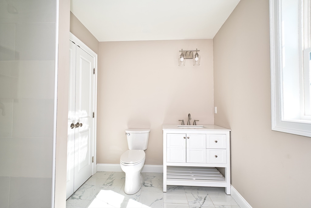 124 Downing Street Fall River, MA 02723 - Photo 23 of 33 a white toilet sitting next to a bathroom sink