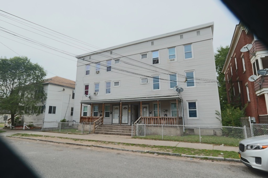 276-278 Centre Street Springfield, MA 01151 - Photo 18 of 21 a view of a white house with a large windows and a yard in front of it