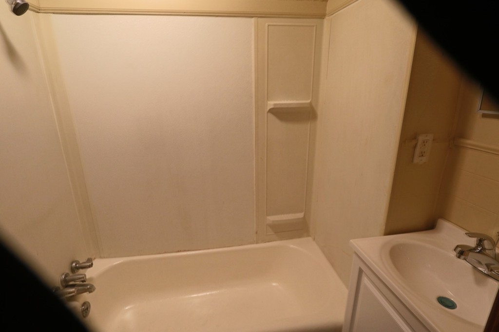 276-278 Centre Street Springfield, MA 01151 - Photo 2 of 21 a bathroom with a white bath tub
