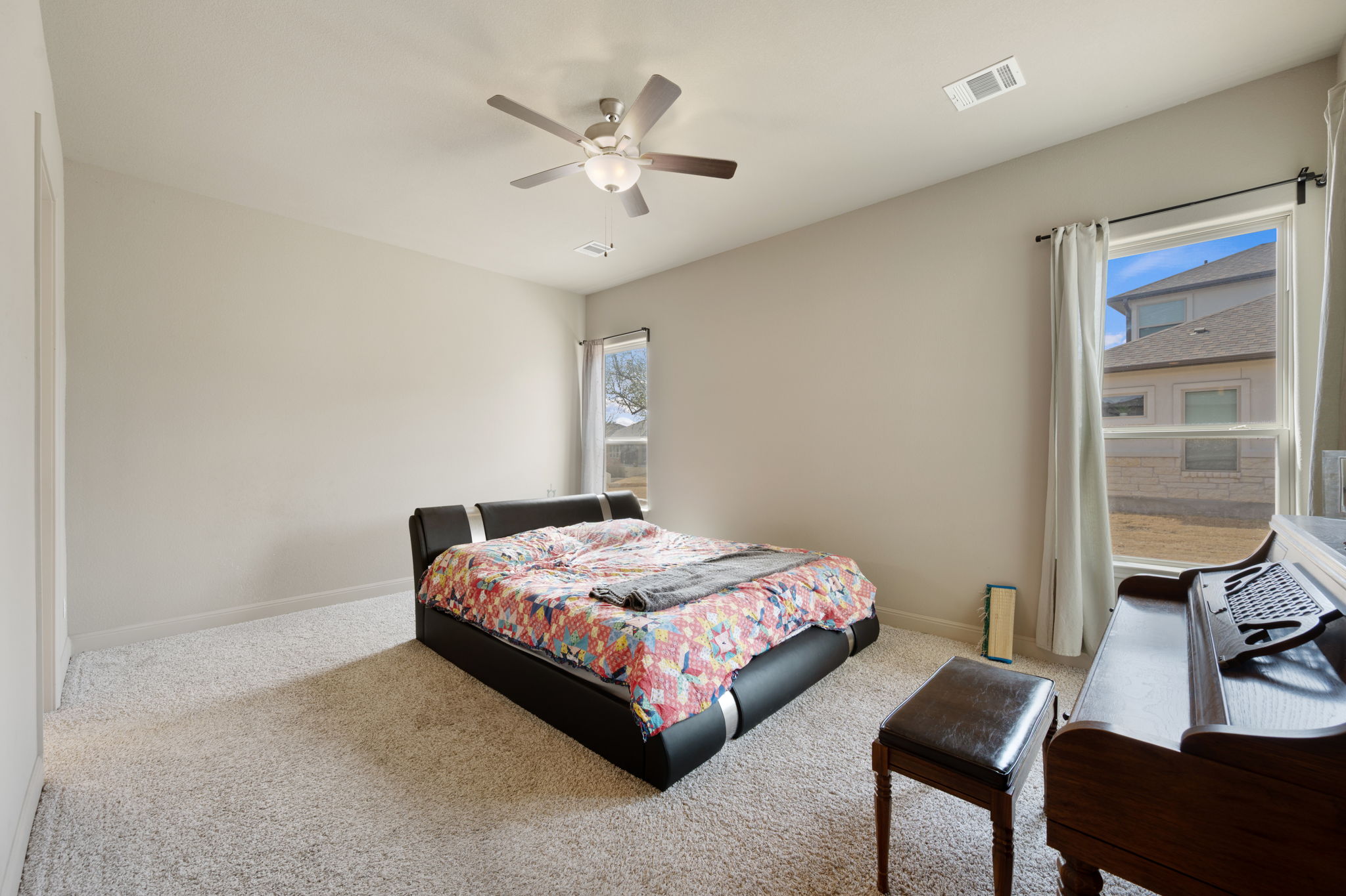 205 Clubhouse Drive, Unit G Georgetown, TX 78628 - Photo 11 of 40 a bedroom with a bed and a chandelier