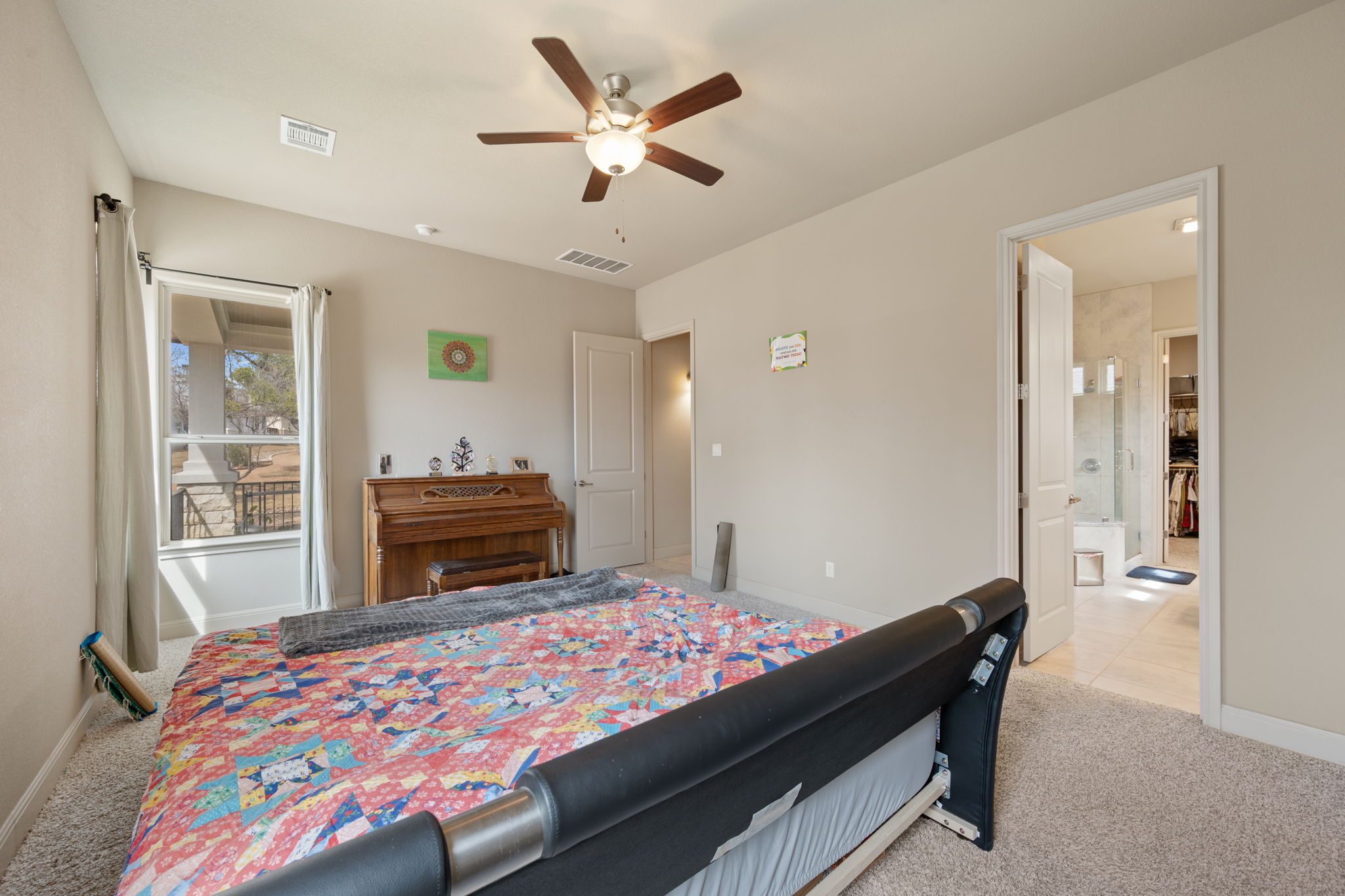 205 Clubhouse Drive, Unit G Georgetown, TX 78628 - Photo 12 of 40 a bedroom with a bed and a chandelier