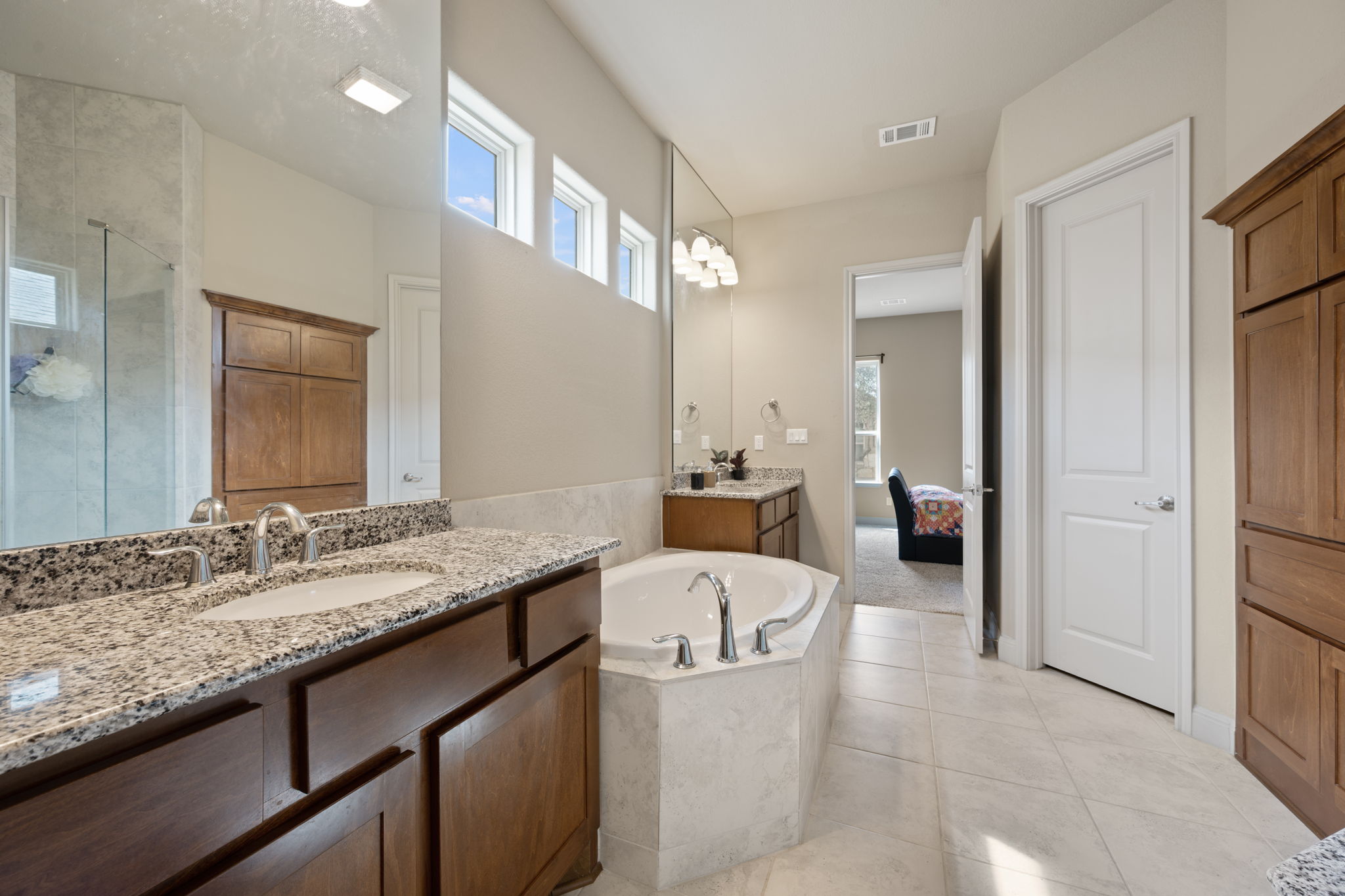 205 Clubhouse Drive, Unit G Georgetown, TX 78628 - Photo 13 of 40 a en suite bathroom with a granite countertop tub sink and mirror