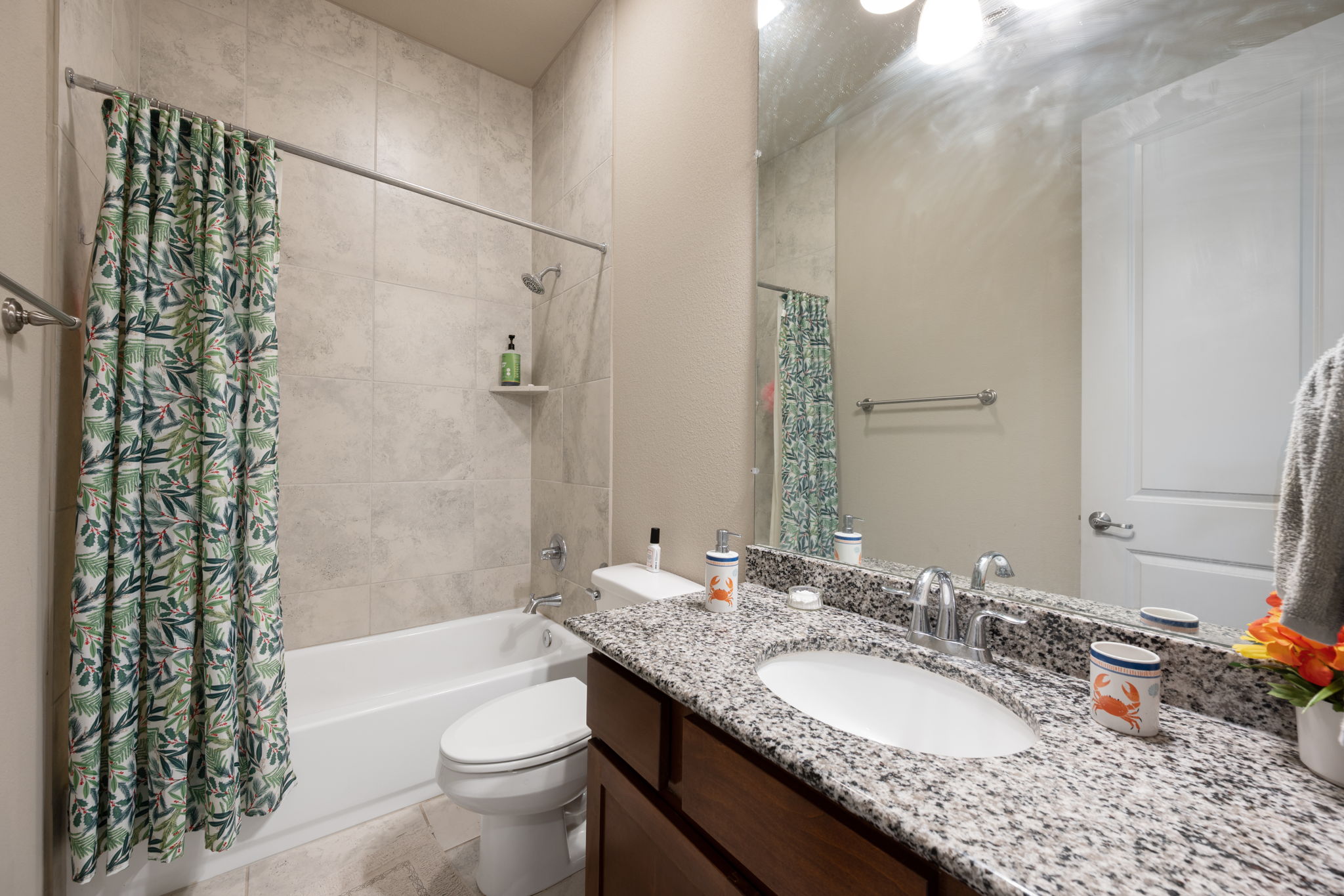 205 Clubhouse Drive, Unit G Georgetown, TX 78628 - Photo 16 of 40 a bathroom with a granite countertop sink toilet mirror and shower