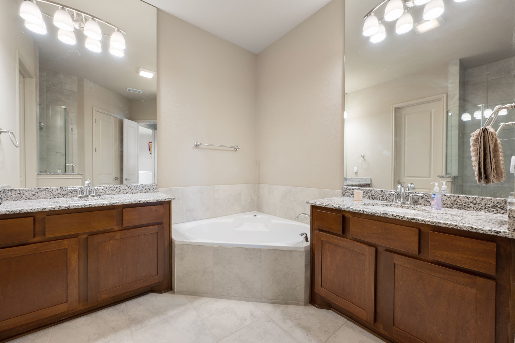 205 Clubhouse Drive, Unit G Georgetown, TX 78628 - Photo 24 of 40 a bathroom with a granite countertop bathtub sink double and mirror