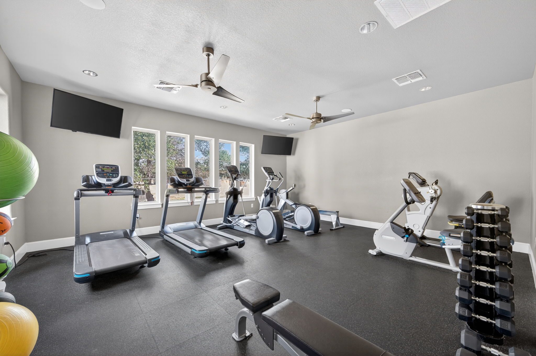 205 Clubhouse Drive, Unit G Georgetown, TX 78628 - Photo 36 of 40 a room with gym equipment and a large window