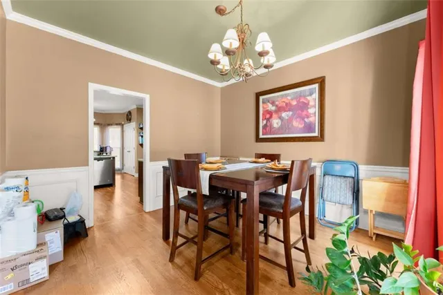 a view of a dining room with furniture and chandelier