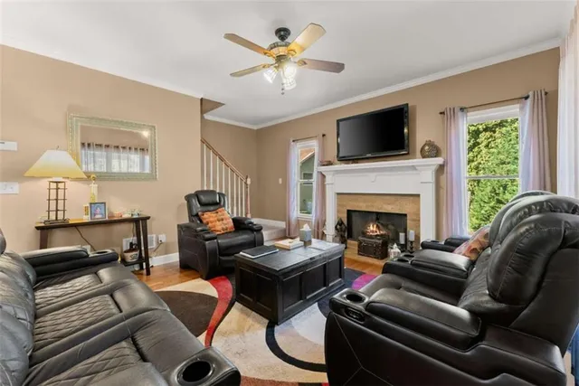 a living room with furniture a large window and a fireplace