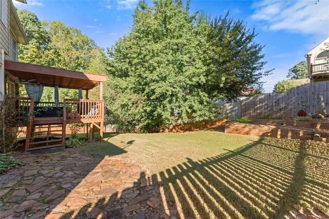 an aerial view of residential houses with outdoor space and trees