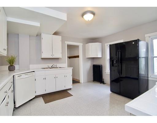 57 Denver Street Springfield, MA 01109 - Photo 4 of 30 a kitchen with granite countertop white cabinets and refrigerator