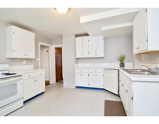 57 Denver Street Springfield, MA 01109 - Photo 6 of 30 a kitchen with granite countertop white cabinets and white appliances