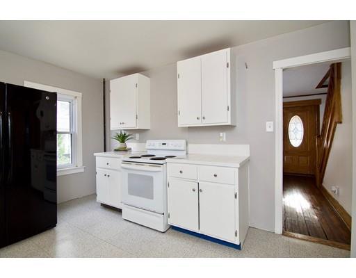 57 Denver Street Springfield, MA 01109 - Photo 7 of 30 a kitchen with granite countertop white cabinets and black appliances