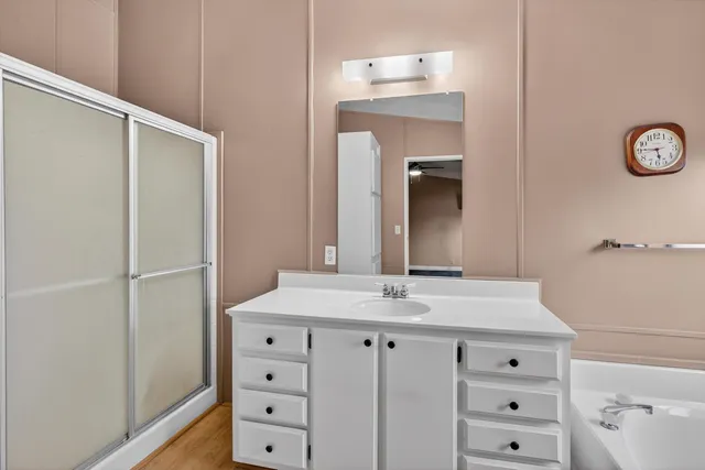 a bathroom with a sink vanity and a mirror