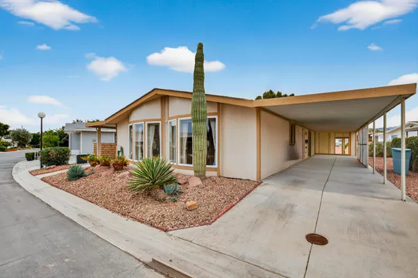 a view of a house with porch and garden