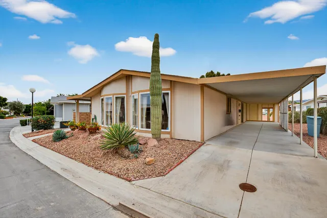 a view of a house with porch and garden