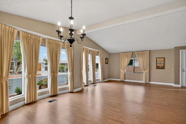 a view of a livingroom with a ceiling fan window and wooden floor