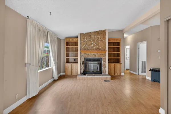 wooden floor fireplace and windows in a room
