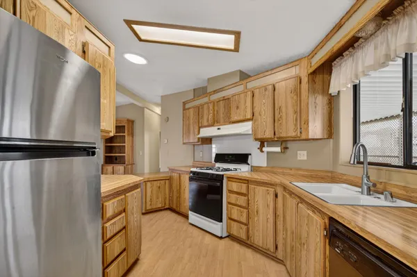 a kitchen with a sink a refrigerator and cabinets