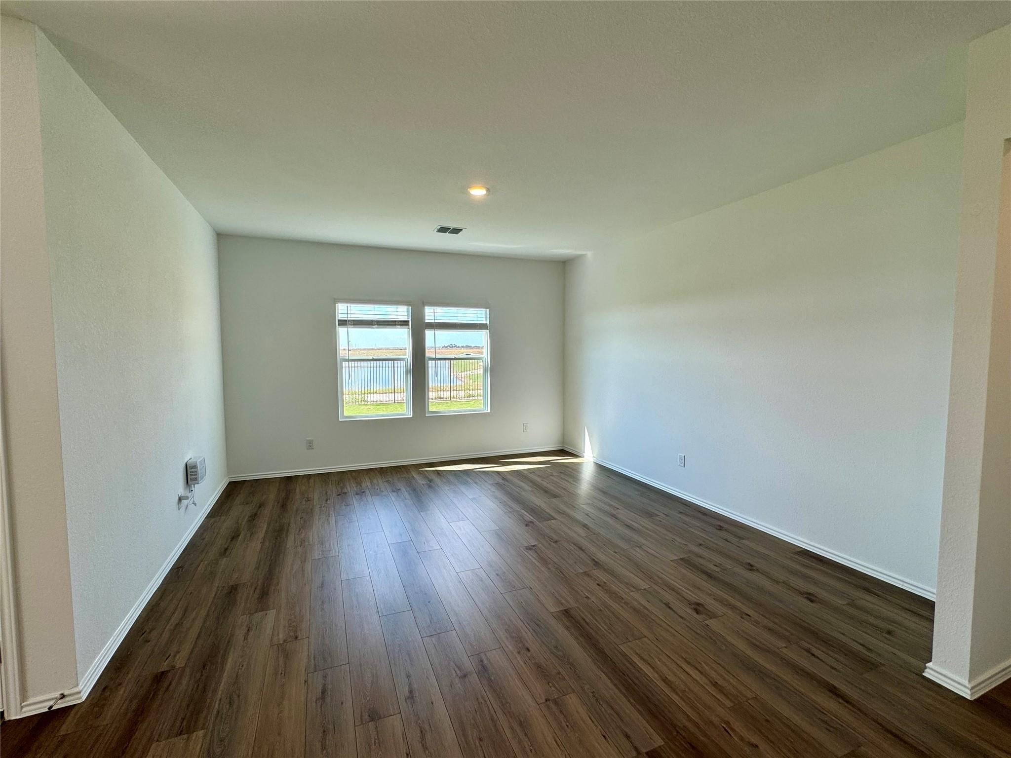 134 Agua Azul Bend Kyle, TX 78640 - Photo 4 of 10 Spare room with dark wood-style flooring and baseboards
