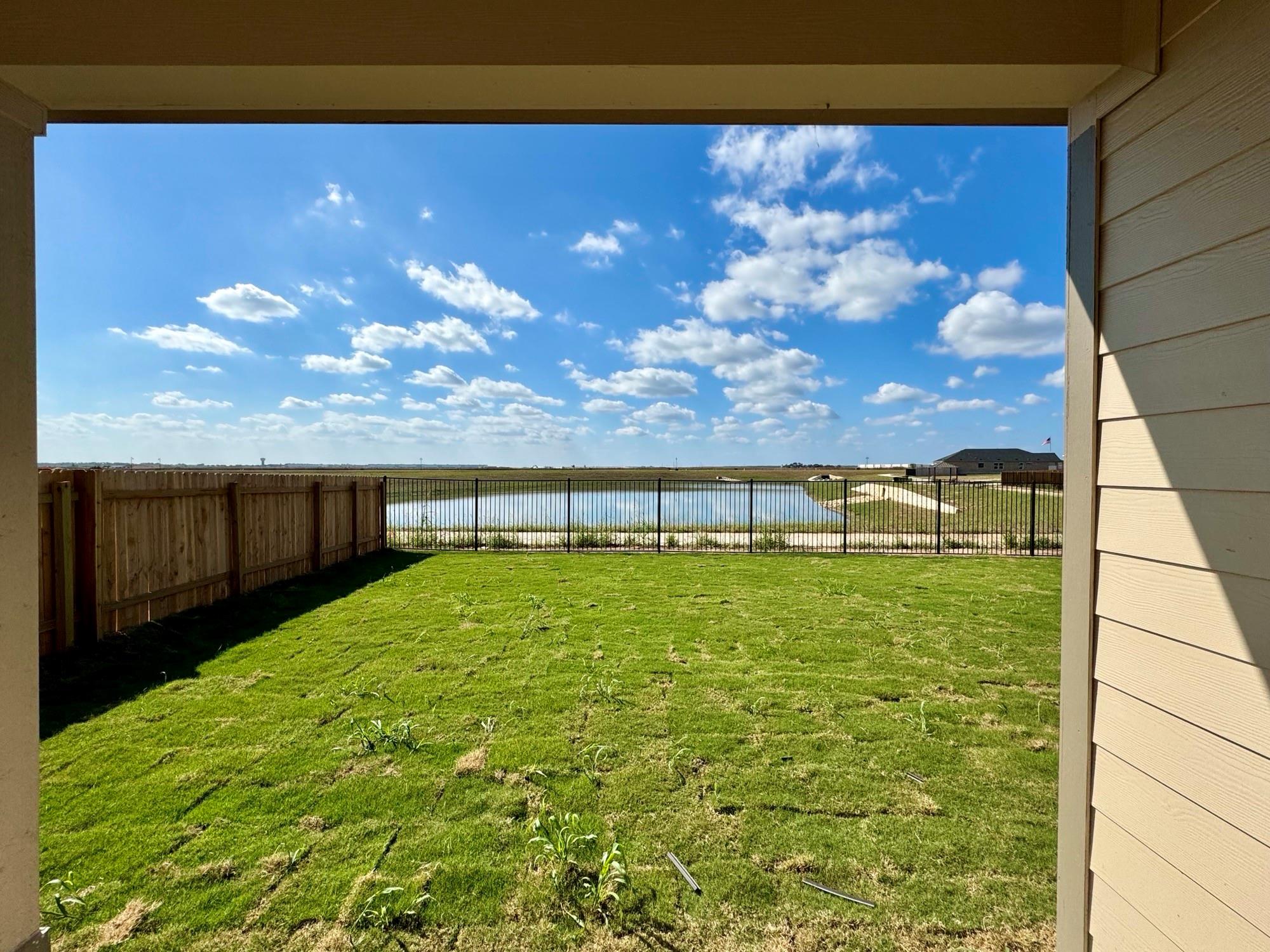 134 Agua Azul Bend Kyle, TX 78640 - Photo 9 of 10 Fenced backyard with a water view and a patio