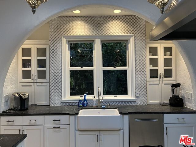 a kitchen with stainless steel appliances a stove a sink and a refrigerator