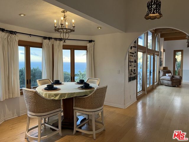 a lamp that is sitting on a bed and a potted plant
