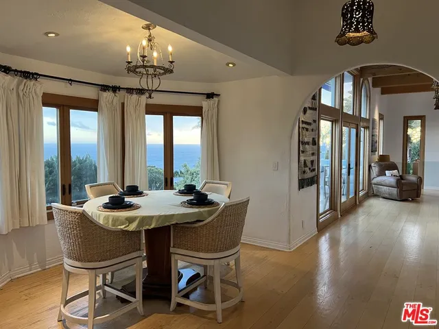 a lamp that is sitting on a bed and a potted plant