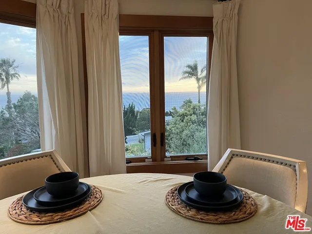 a front view of a room with shelves and a wooden floor