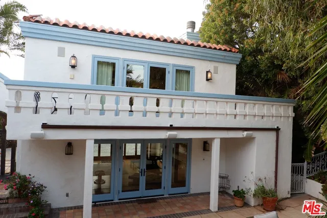 a living room with furniture and large windows